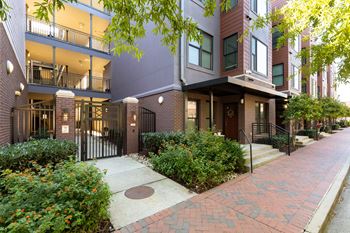 A brick building with a black gate in front.